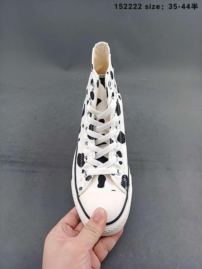 white patterned converse