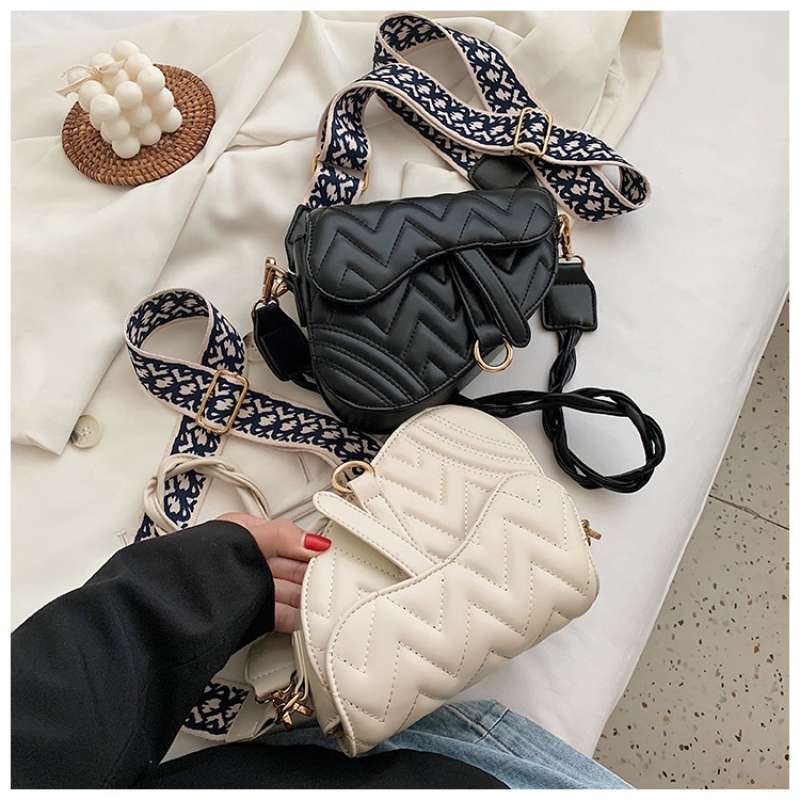 Saddle sling top bag